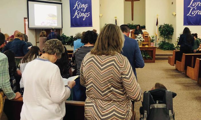 Gathering at 6 p.m. Sunday, March 23 at First Christian Church, Pastor Leah Fort, of First Nazarene Church, brings the message of living and eternal hope from the gospel of John, Chapter 20, to the crowd at the Collinsworth County Ministerial Alliance Community Easter Service. The Red River Sun/Bev Odom