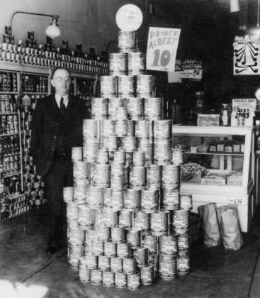 In the 1930s, the late E.F. Lewis stands next to a display in his business, Lewis Grocery. Located on the southeast corner of the downtown Wellington square at 900 East Ave., the store display is a tall pyramid of Prince Albert 10cent tobacco cans. The space has been exquisitely renovated into an additional Wellington Ritz Theatre venue. Photo Courtesy of The Portal to Texas History