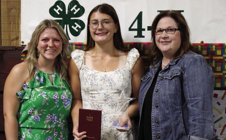 Taylor Wiseman, center, receives the Childress County 4-H Gold Star from 4-Her Savannah Rabe and Childress County Judge Kimberly Jones.