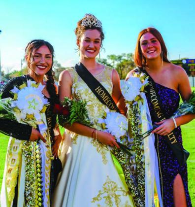 Queen nominees Audrey Chavera, left, and Ava Arant, right, surround 2022 Memphis High School Homecoming Queen Maggie Cook.